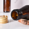 Fabricant de bouteilles de sirop en verre ambré recyclées en verre scellé de 100ml avec capuchon en métal